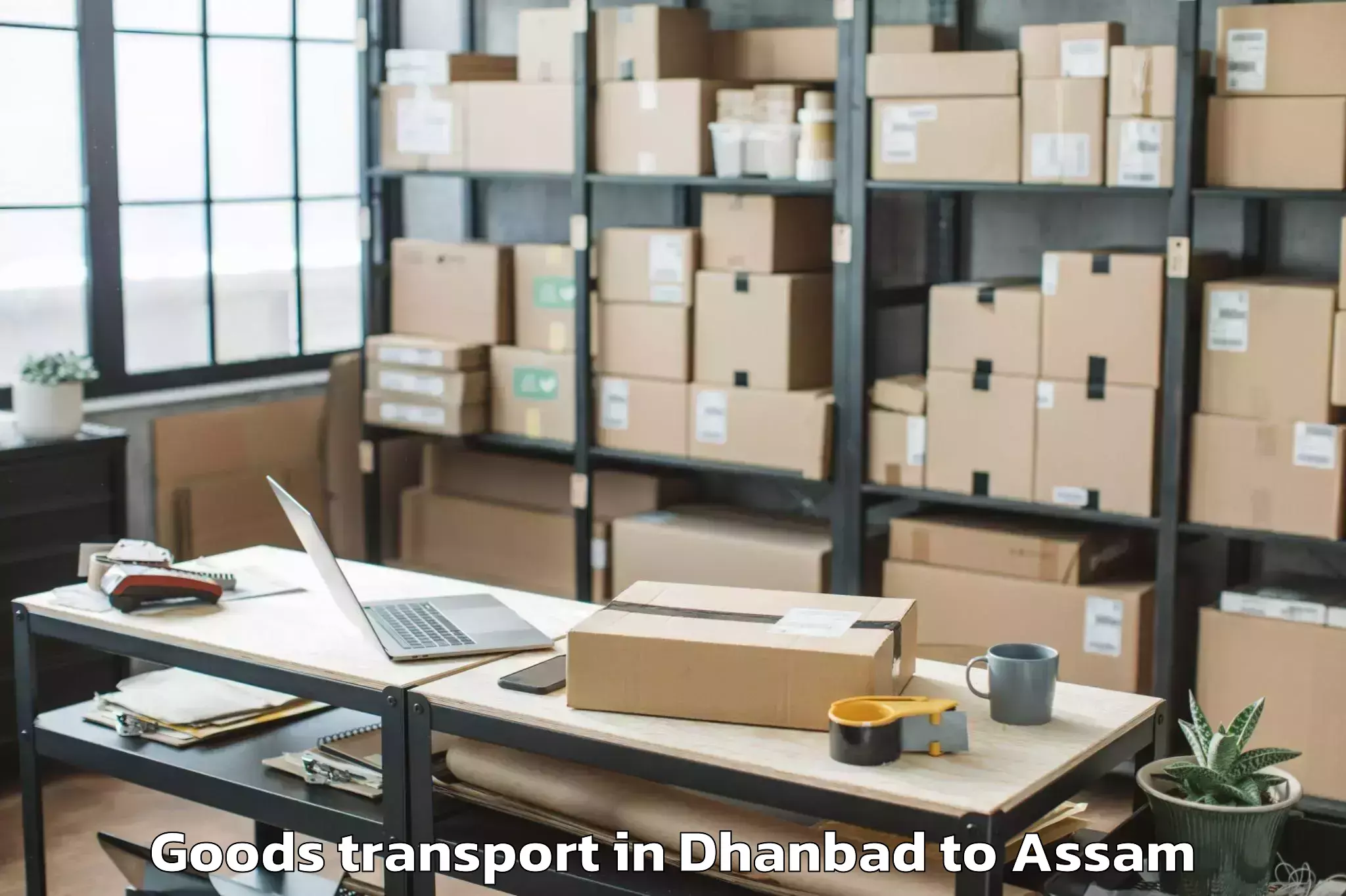 Book Dhanbad to Goshaingaon Goods Transport Online